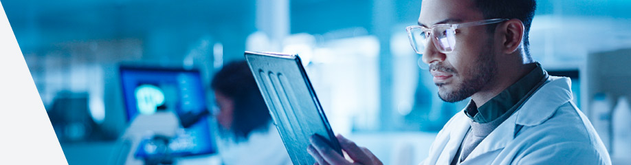 Man in laboratory reading notes