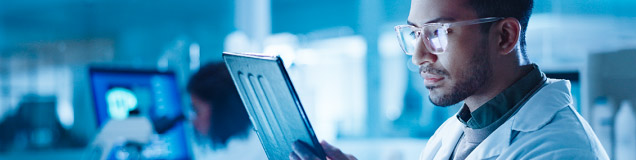 Man in laboratory reading notes